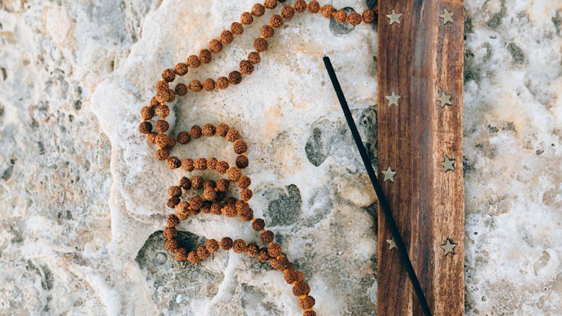 Silhouette of a woman practicing yoga at sunrise.