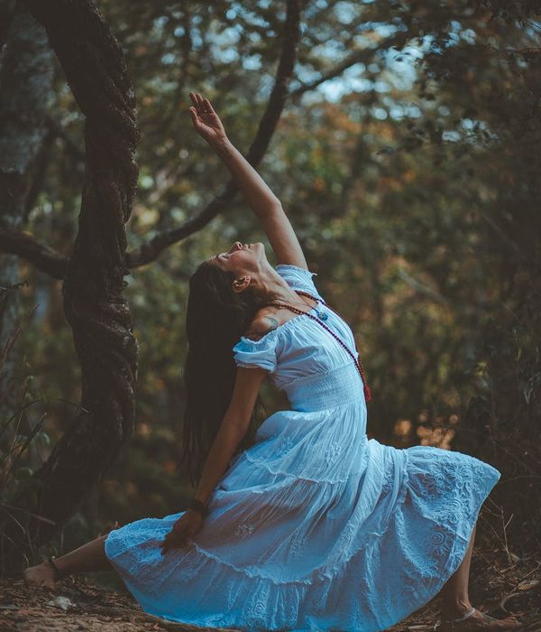 Woman in a graceful yoga pose with accent lights.